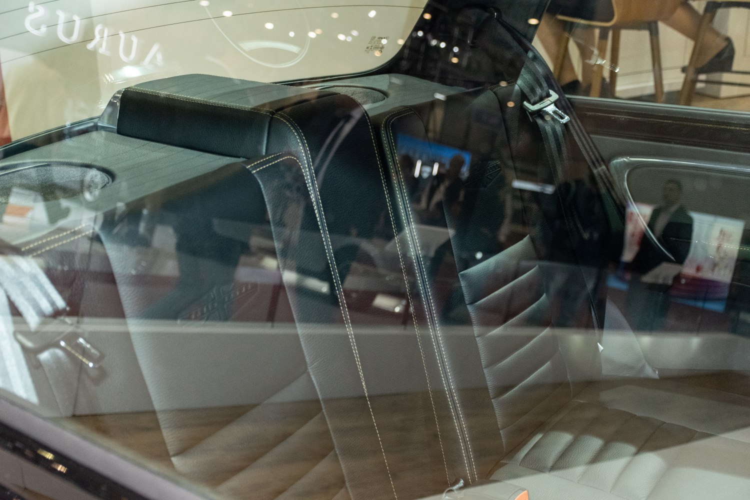 Leather rear seats with detailed white stitching and integrated seatbelt