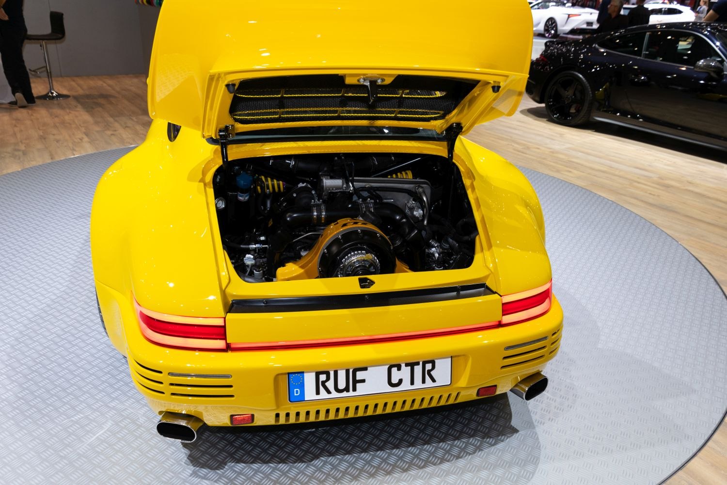 Rear open engine compartment with turbocharged powertrain and rear LED lights.