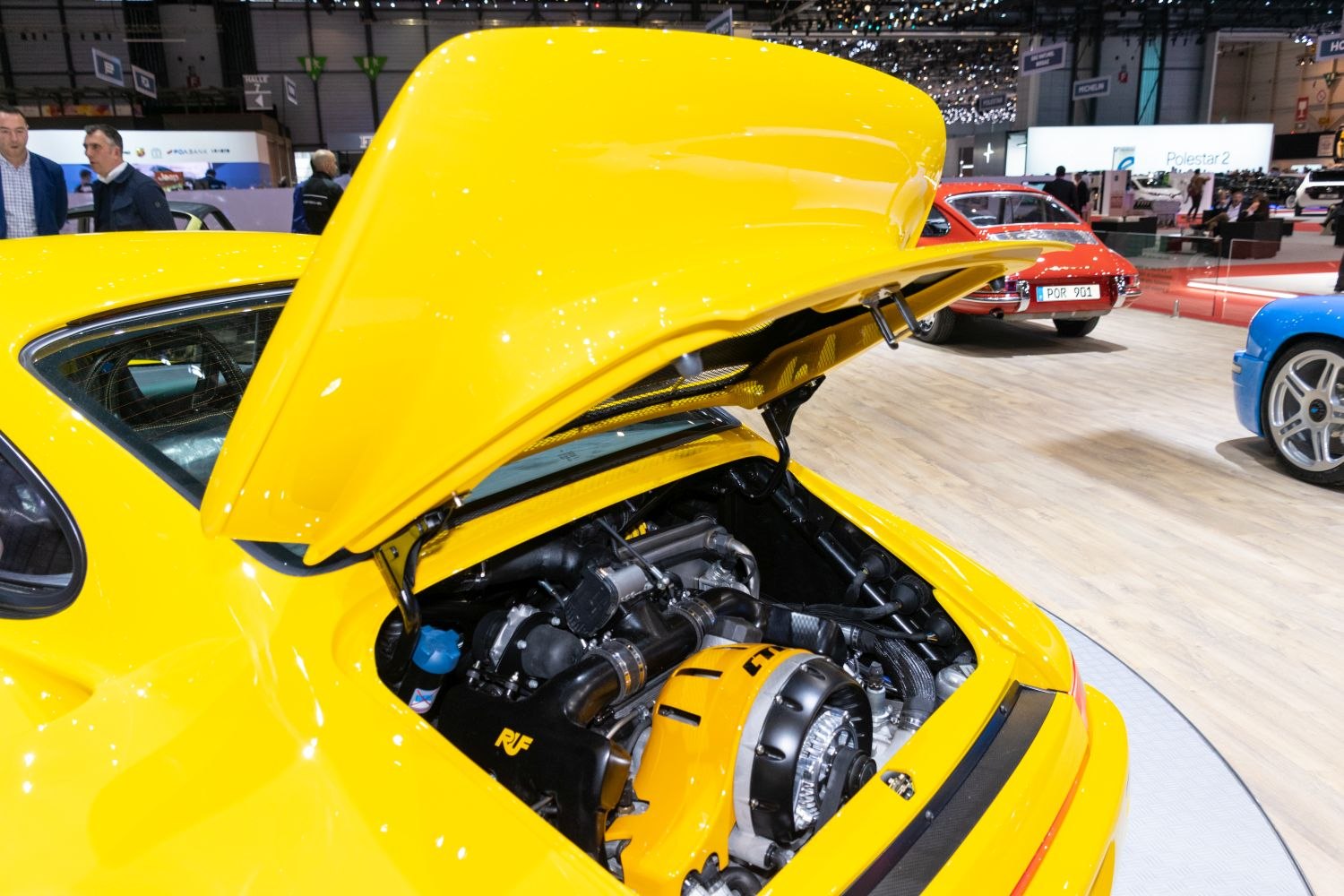 Open rear engine bay with high-performance components in bright yellow car