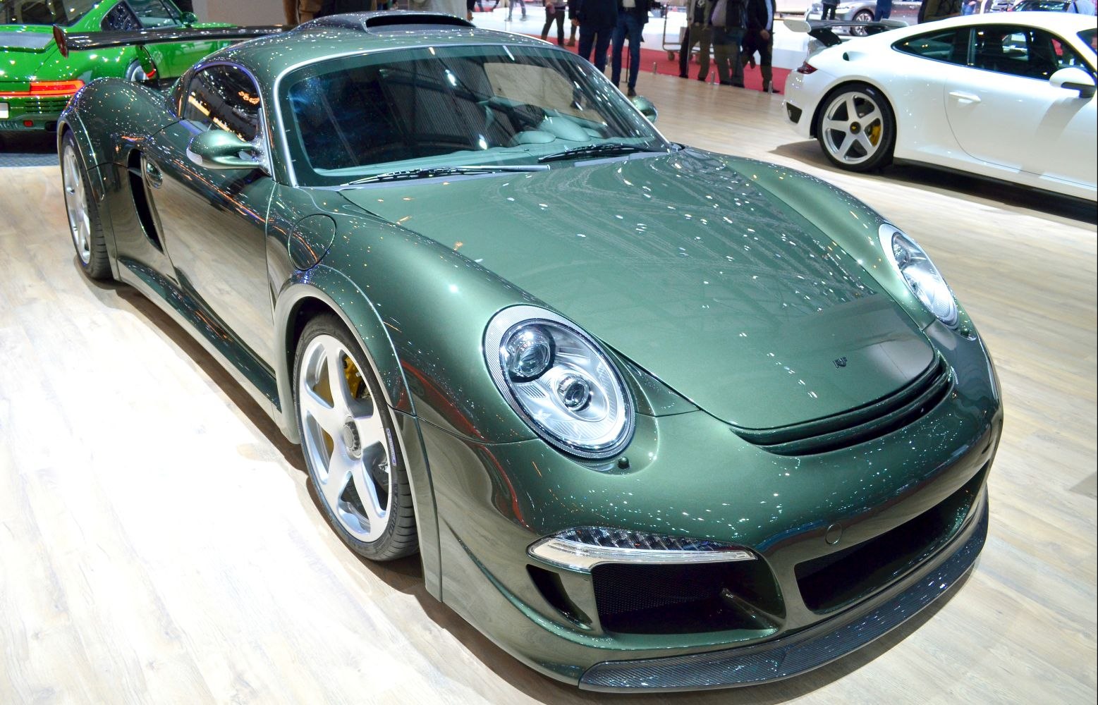 Green aerodynamic sports coupe with modern headlights and front grille