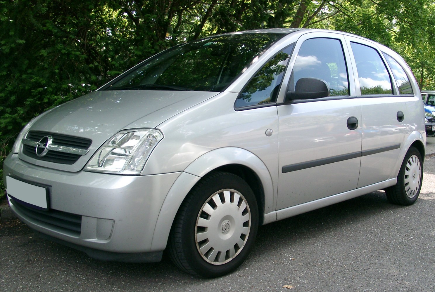 Silver compact hatchback with rounded design, front and side view