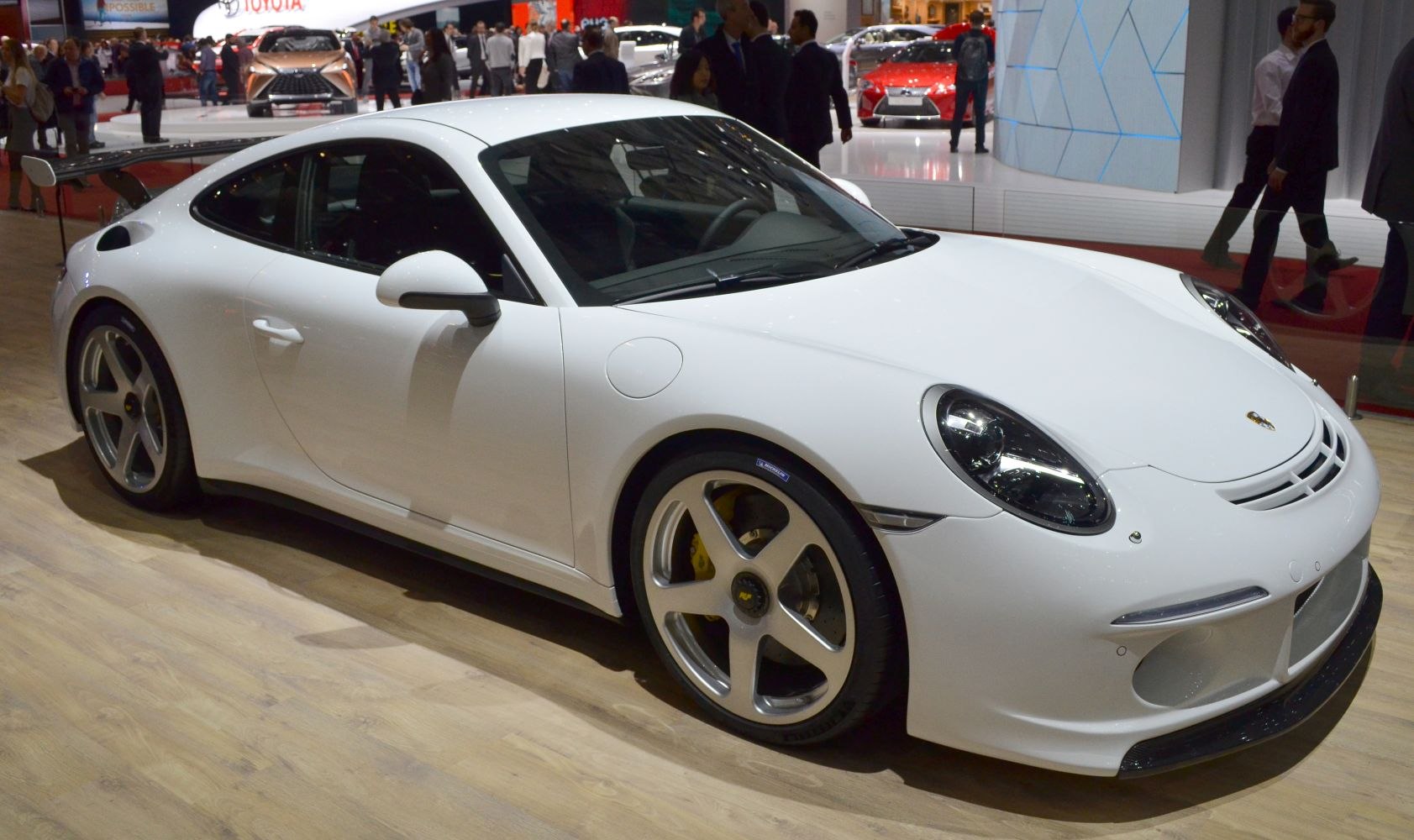 White two-door sports coupe with aerodynamic vents and rear wing
