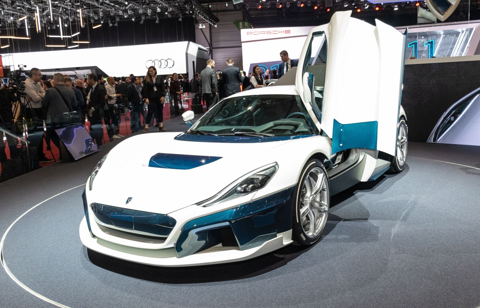 White sports car with butterfly doors and aerodynamic design.