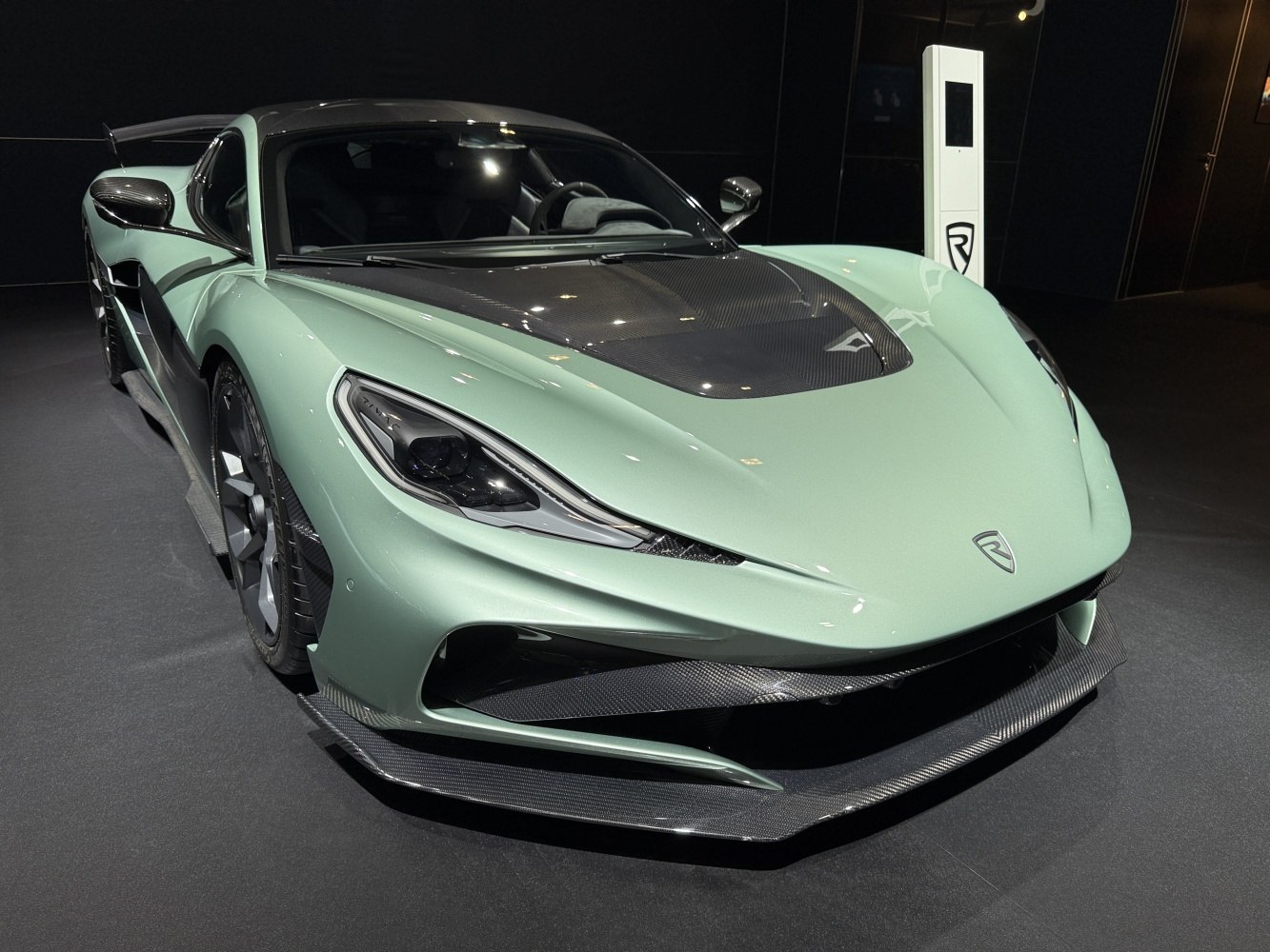Aerodynamic sports car front with carbon fiber hood and splitter