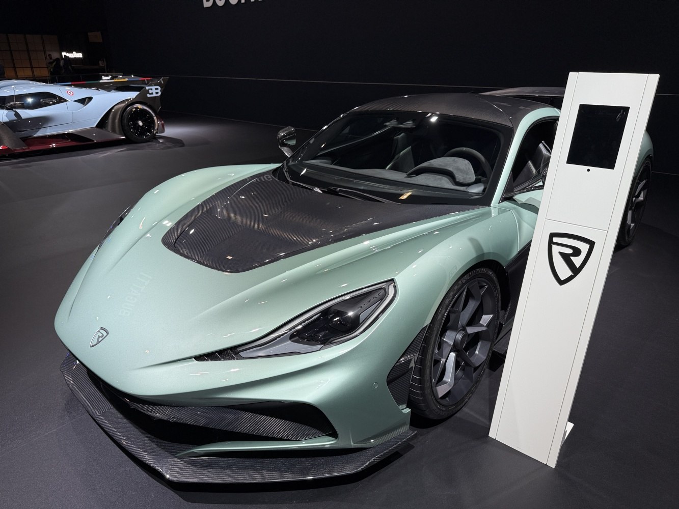 Front and side view with carbon fiber accents and aerodynamic design.
