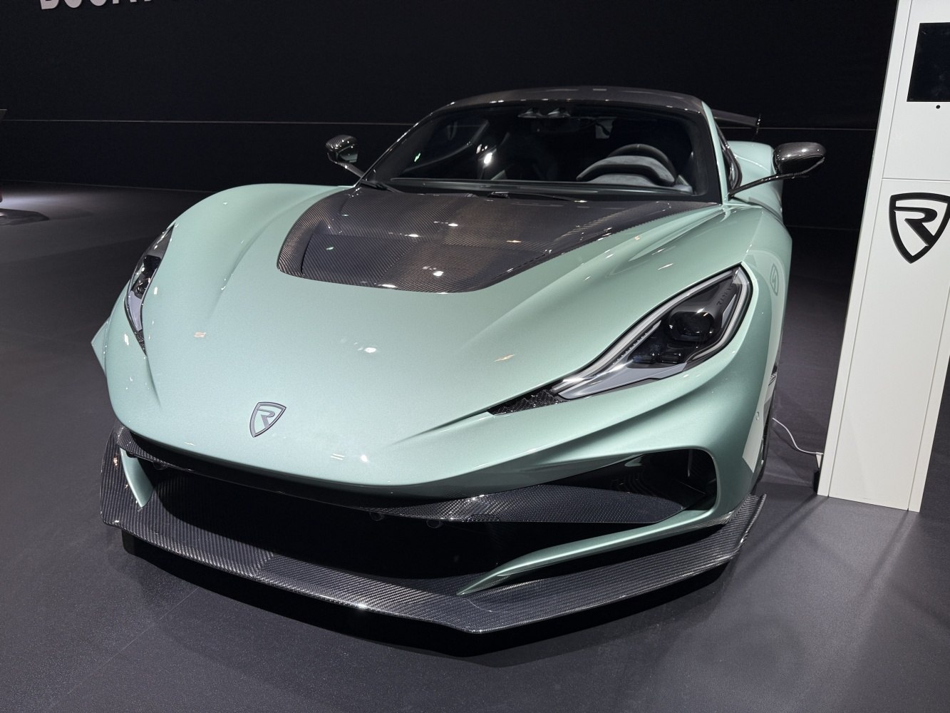 Front view of car with carbon fiber hood and aerodynamic splitter.