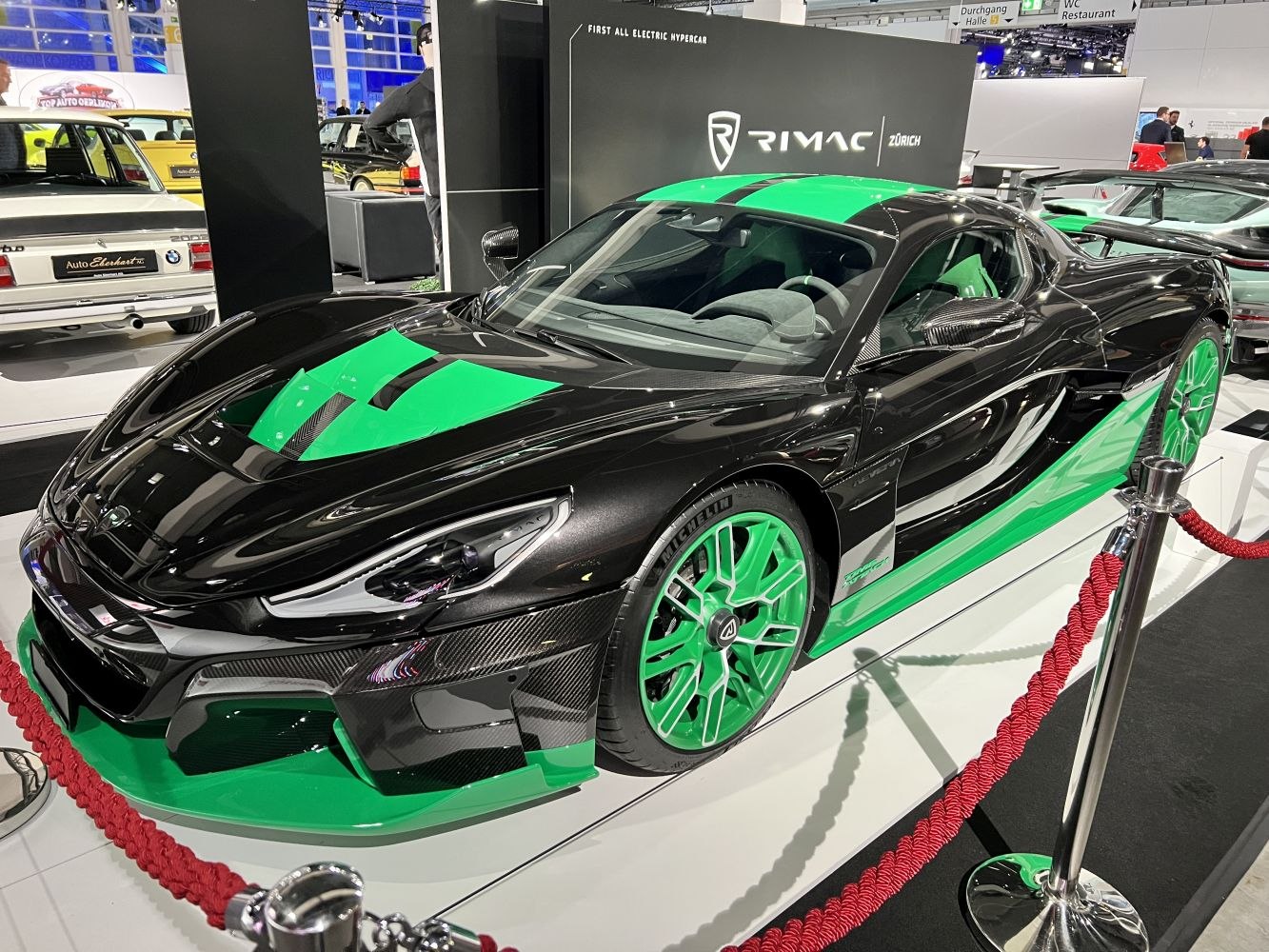 Electric hypercar with green accents and aerodynamic carbon fiber design