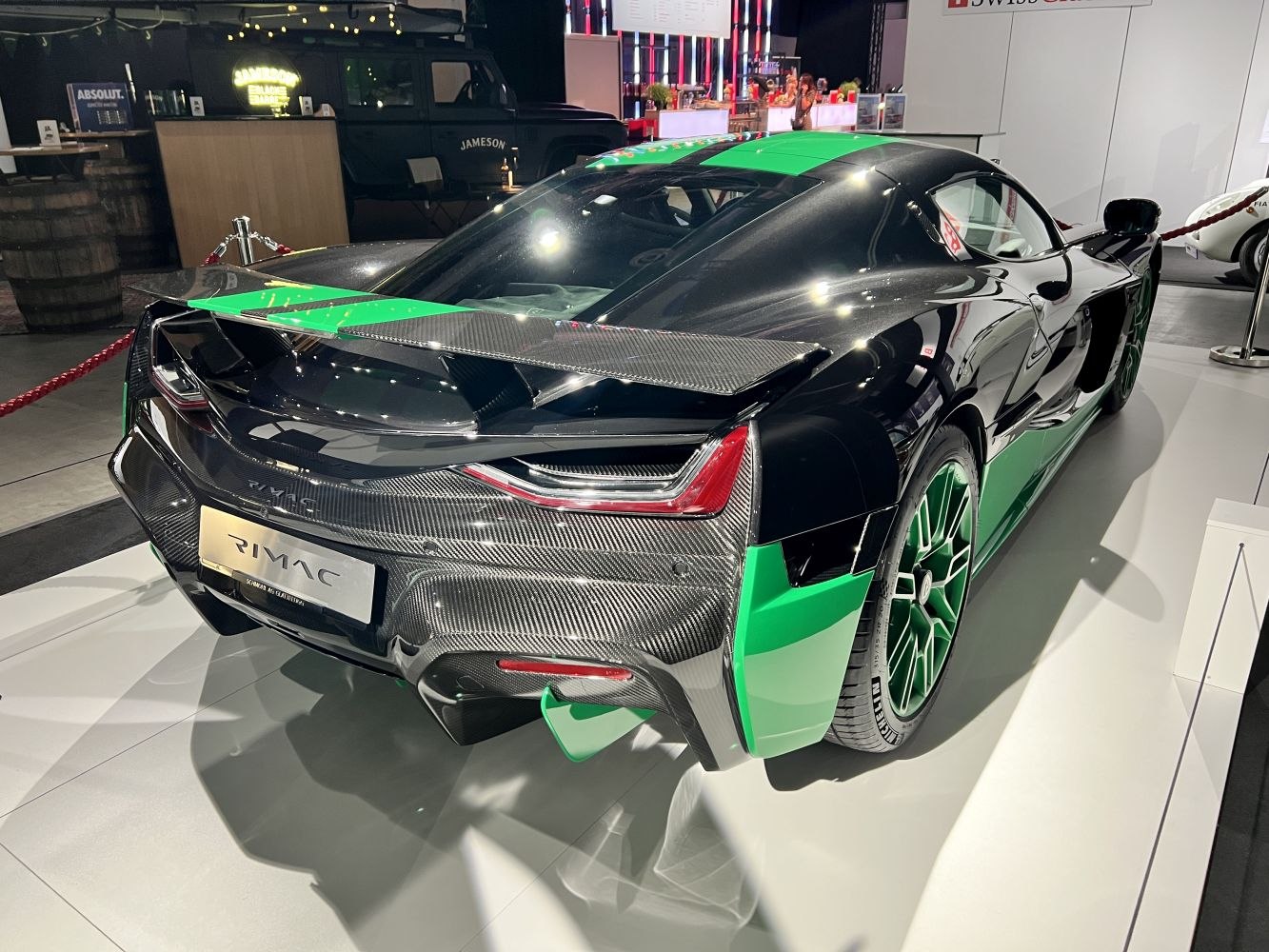 Rear view with carbon fiber and green accents on an electric hypercar