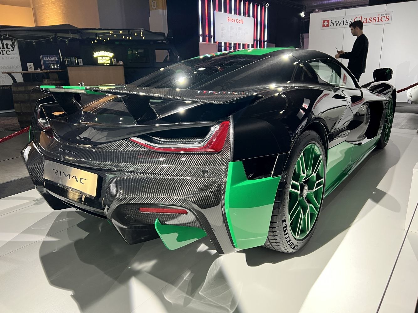 Hypercar rear with carbon fiber, green accents, aerodynamic wing and performance wheels