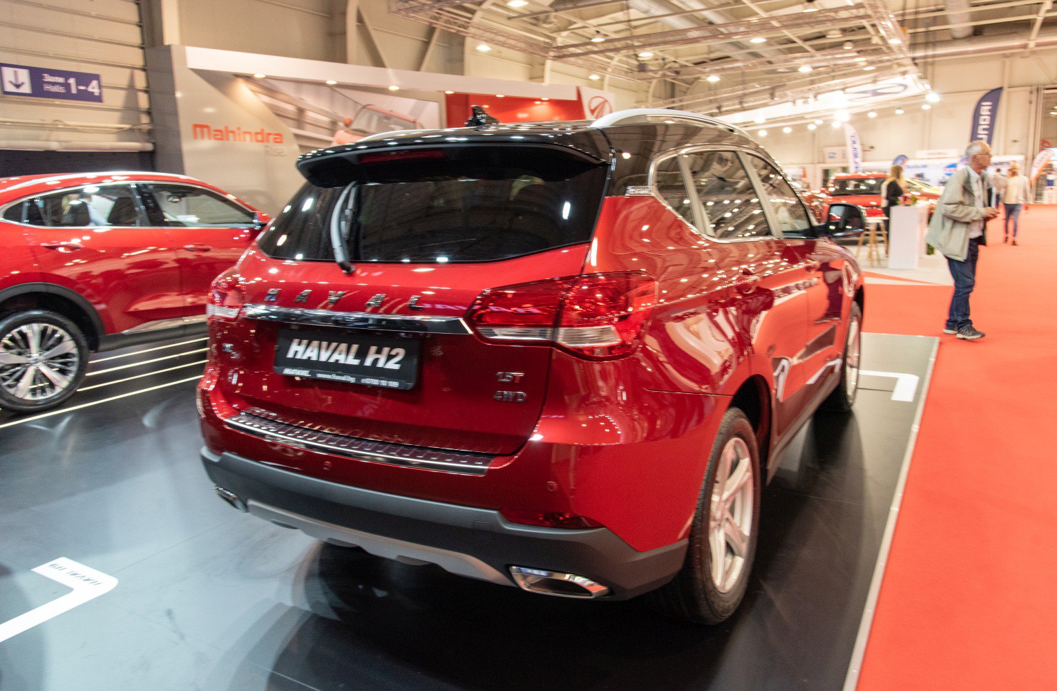 Red SUV rear view with dual exhaust and roof spoiler