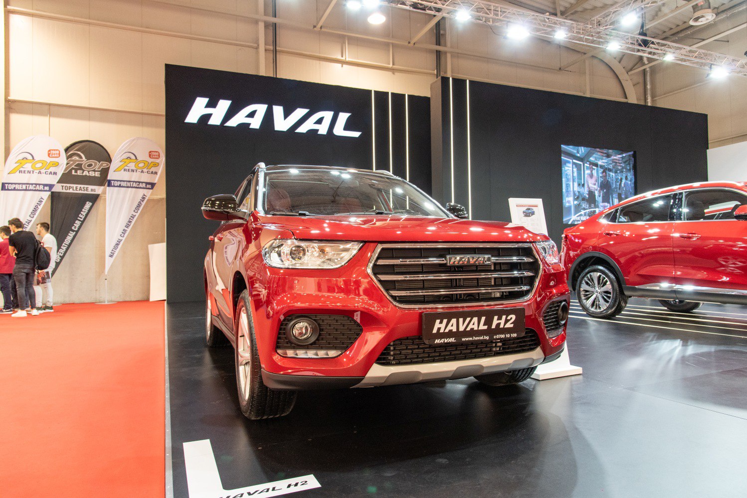 Front view of red SUV with prominent grille and headlights