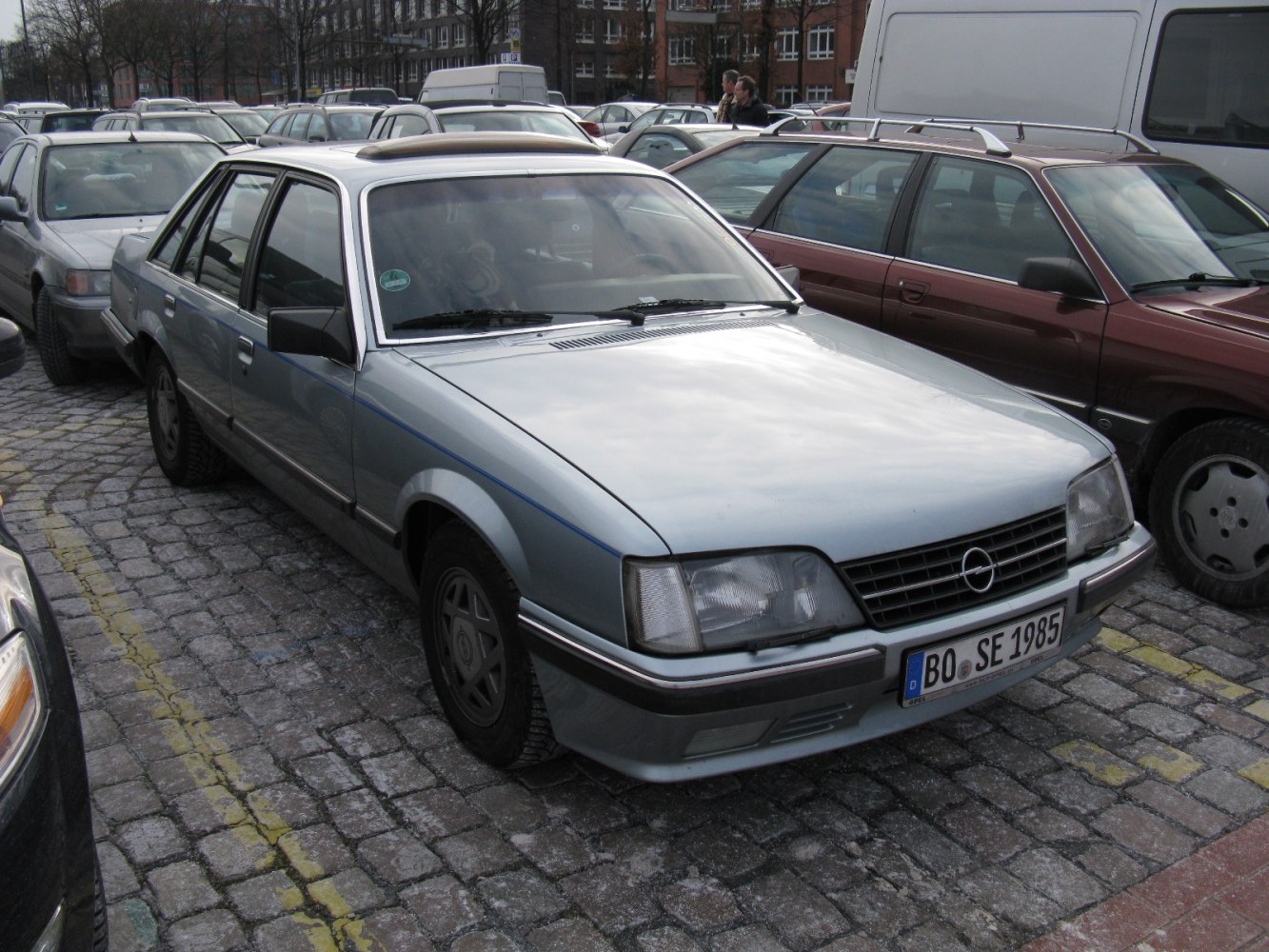 Front side view of a classic 1980s sedan with distinctive headlights and grille.