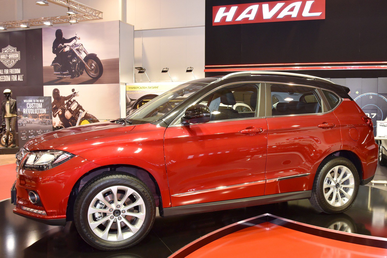 Red compact SUV side profile with alloy wheels and black roof rails