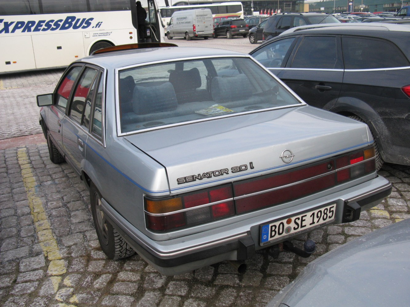 Angular sedan rear with rectangular taillights and chrome trim