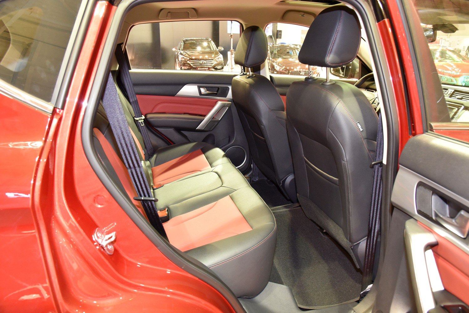 Rear passenger seat with two-tone leather upholstery and spacious legroom.