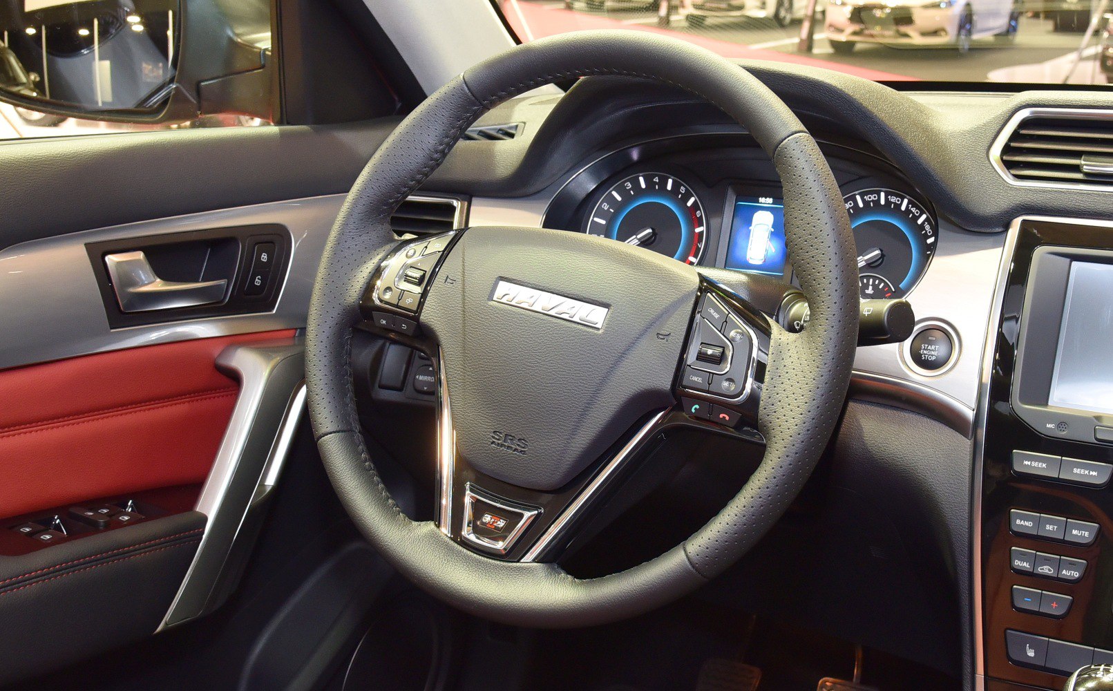 Steering wheel with controls, instrument cluster, and dashboard panel.