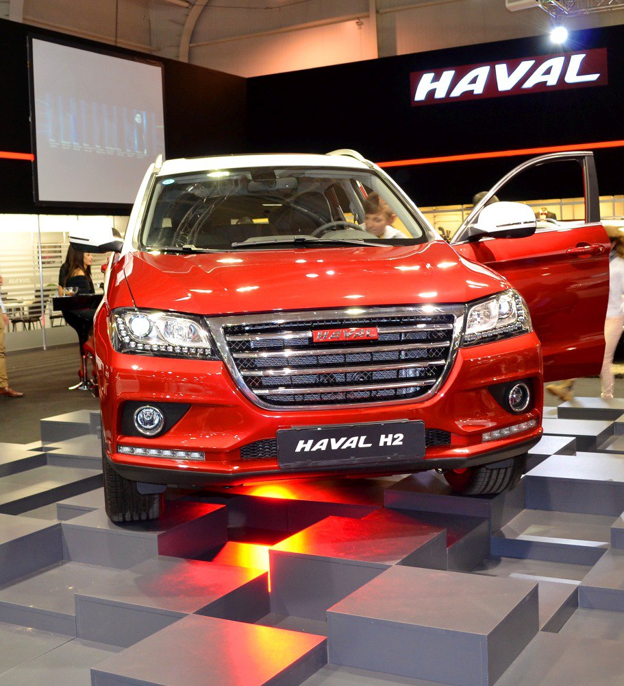 Front view of SUV with chrome grille and LED headlights on illuminated steps