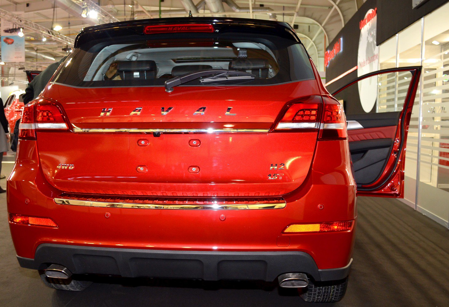 Red SUV rear with 4WD badge, dual exhaust, and rear windshield wiper