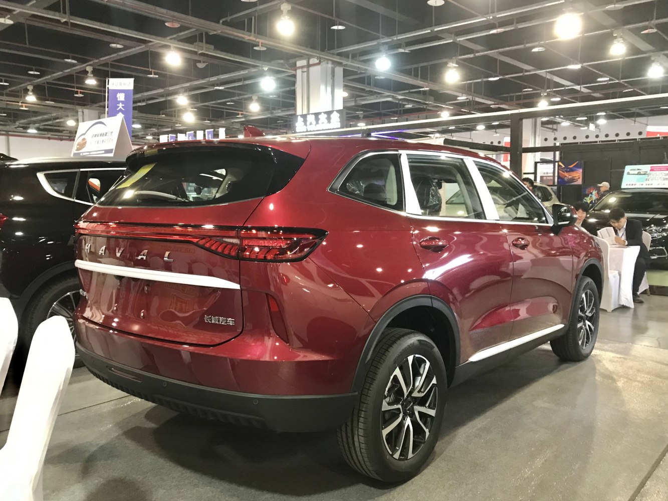 Rear side view of modern SUV with distinctive taillights and red paint