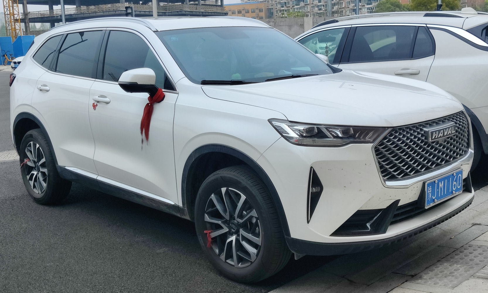 White SUV with bold grille and sleek LED headlights with daytime running lights