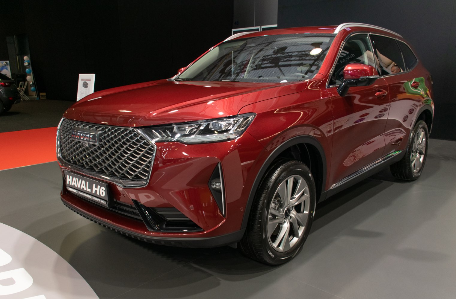 Front view of modern SUV with diamond mesh grille and sleek headlights.