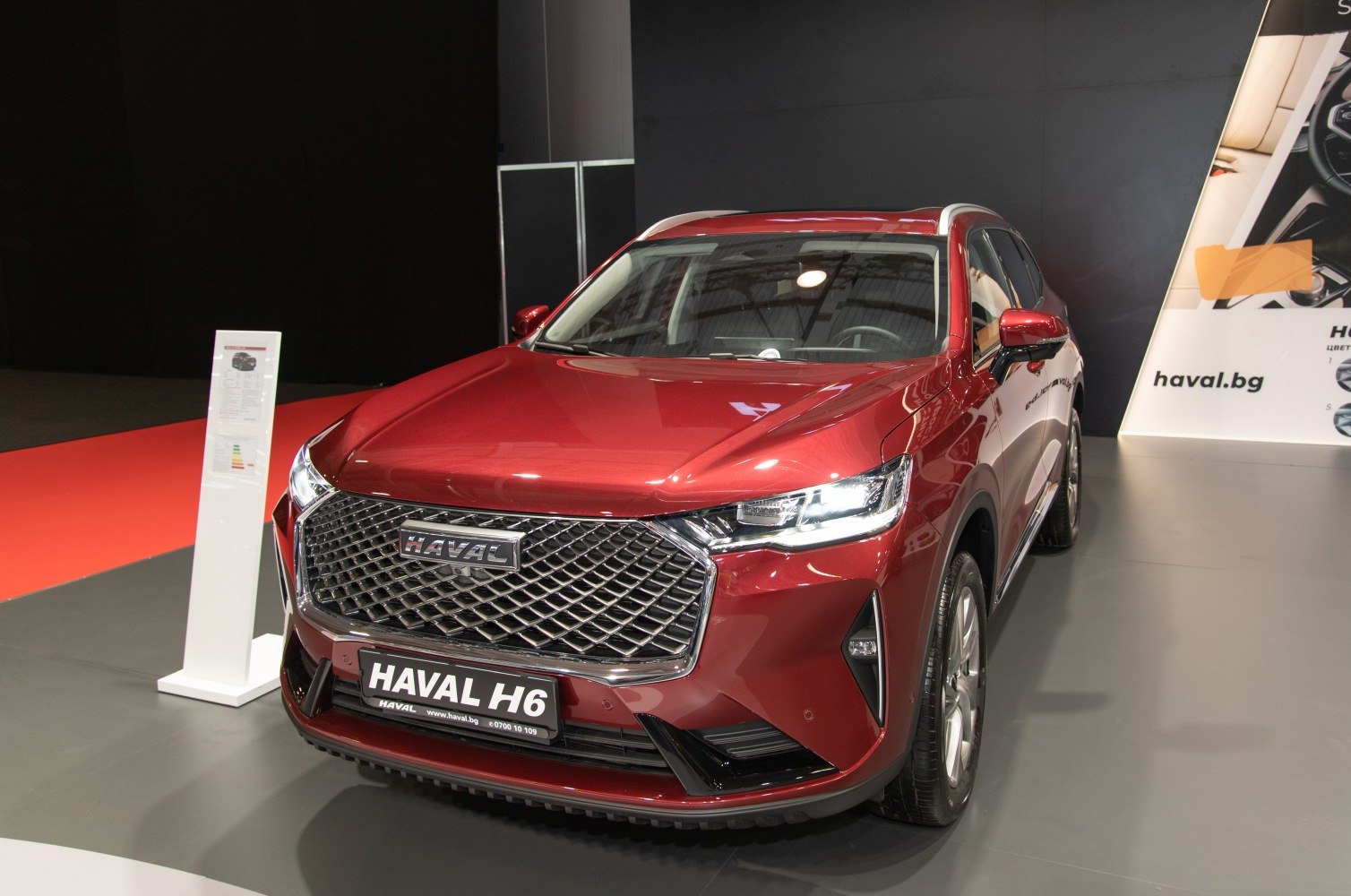 Front grille and LED headlights of a red SUV
