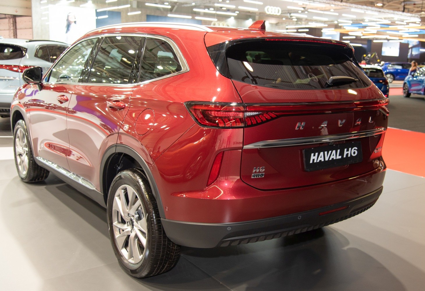 Red SUV rear with sleek horizontal tail lights and chrome trim