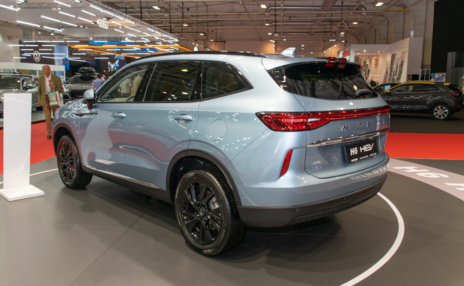 Hybrid SUV rear side view with black wheels and LED tail lights