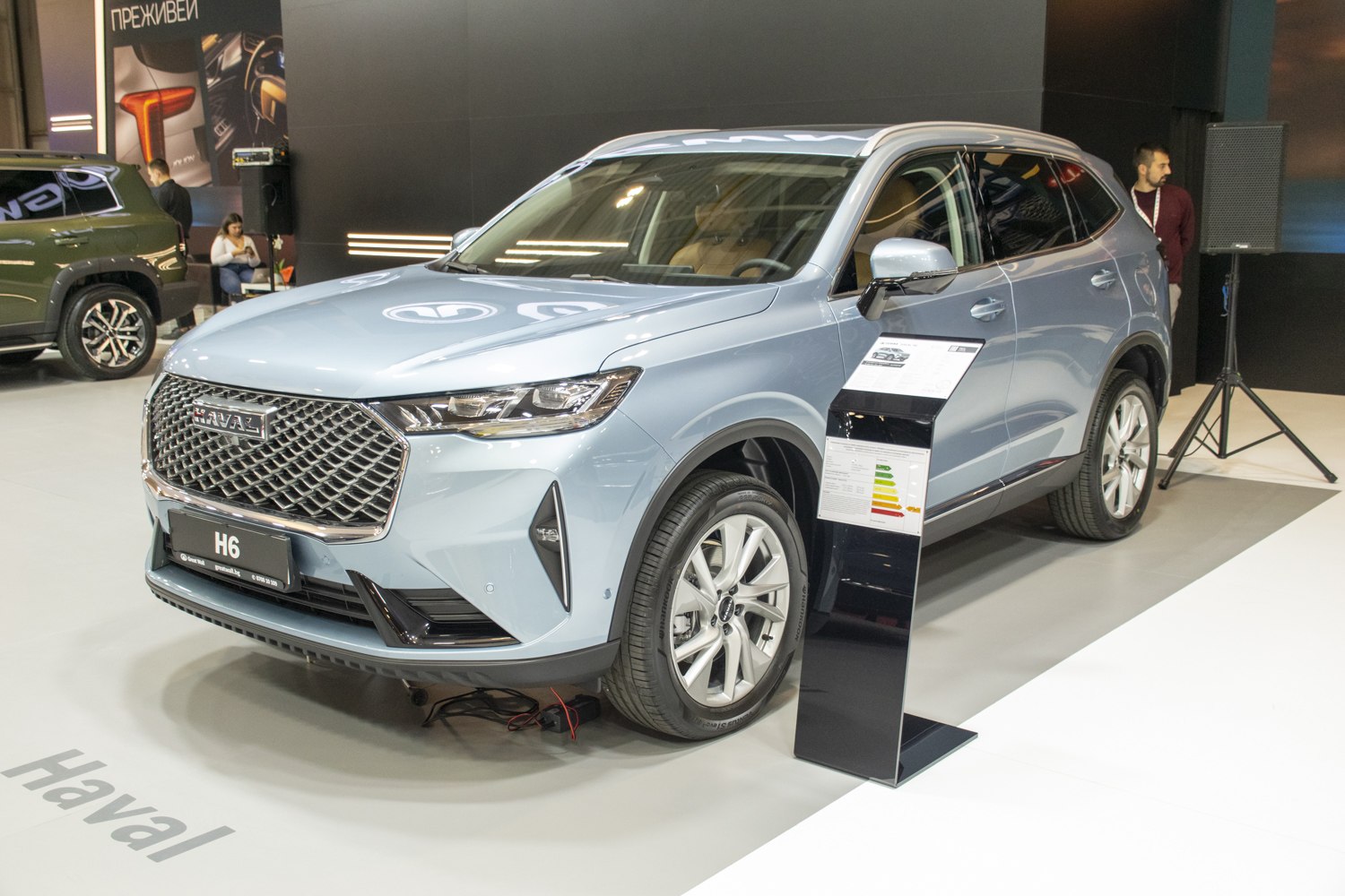 Large mesh grille and modern LED headlights from front angle