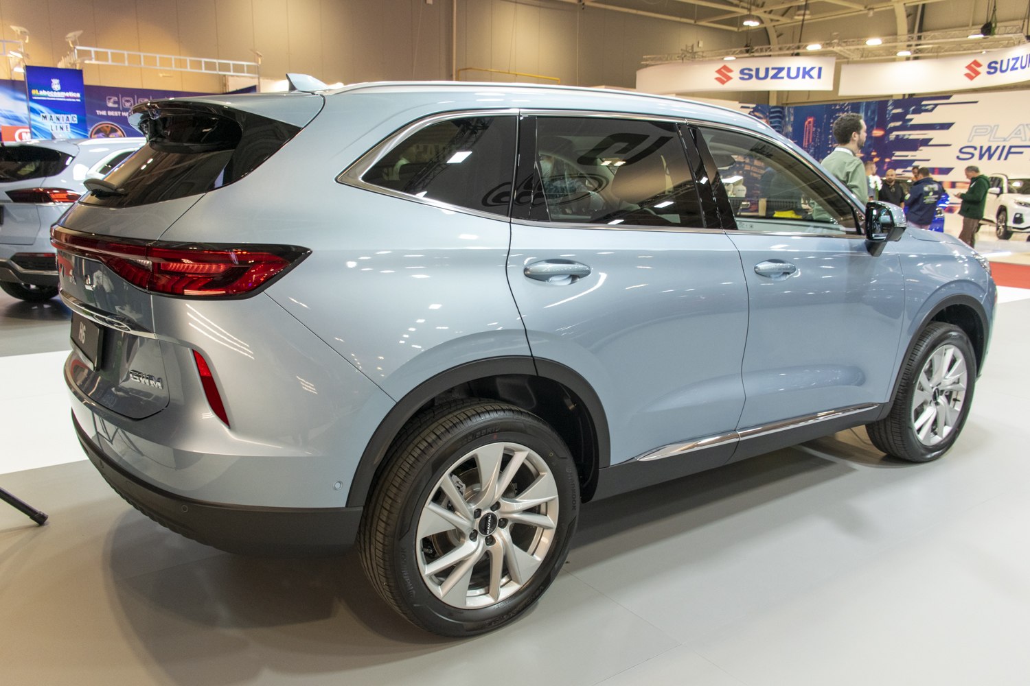 Rear side view of a sleek modern SUV with alloy wheels.