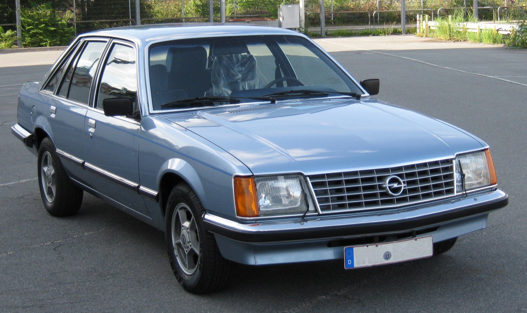 Front side view with chrome grille and rectangular headlamps