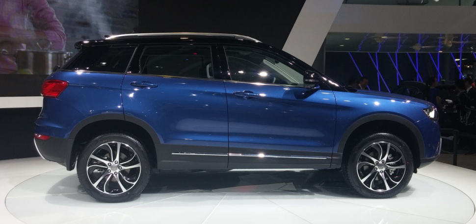 Side profile of blue SUV with alloy wheels and sleek roofline
