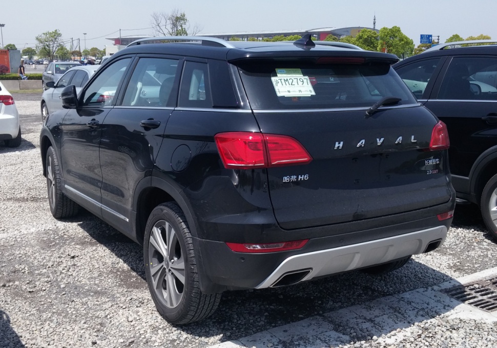 High-angle rear view of a compact SUV with dual exhausts and roof rails