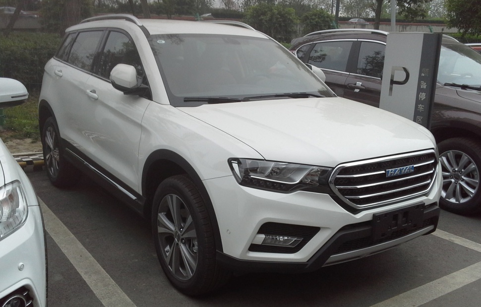 White SUV with chrome grille and LED headlights in parking lot