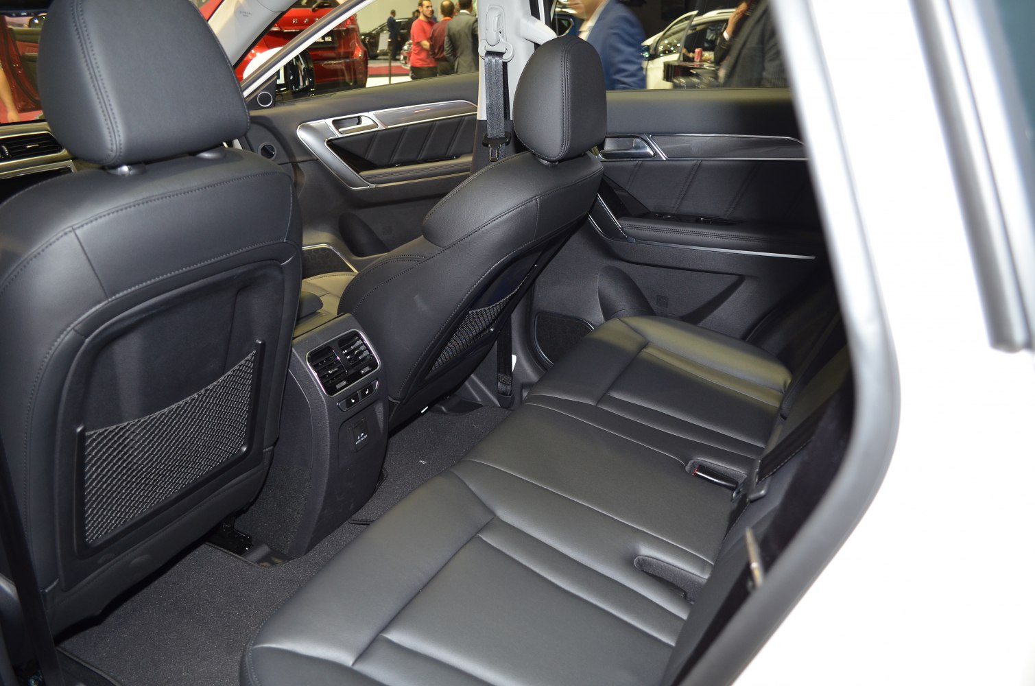 Rear leather seats and interior with rear air vents and seat pocket nets.