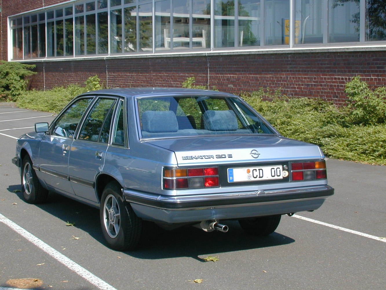 Rear view of classic sedan with rectangular tail lights and chrome bumper