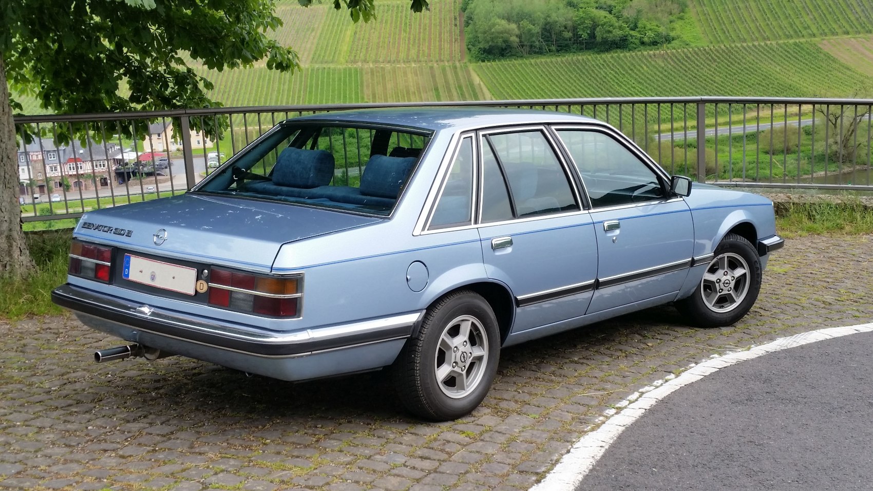 Rear and side view of an angular vintage sedan with distinctive taillights and alloy wheels