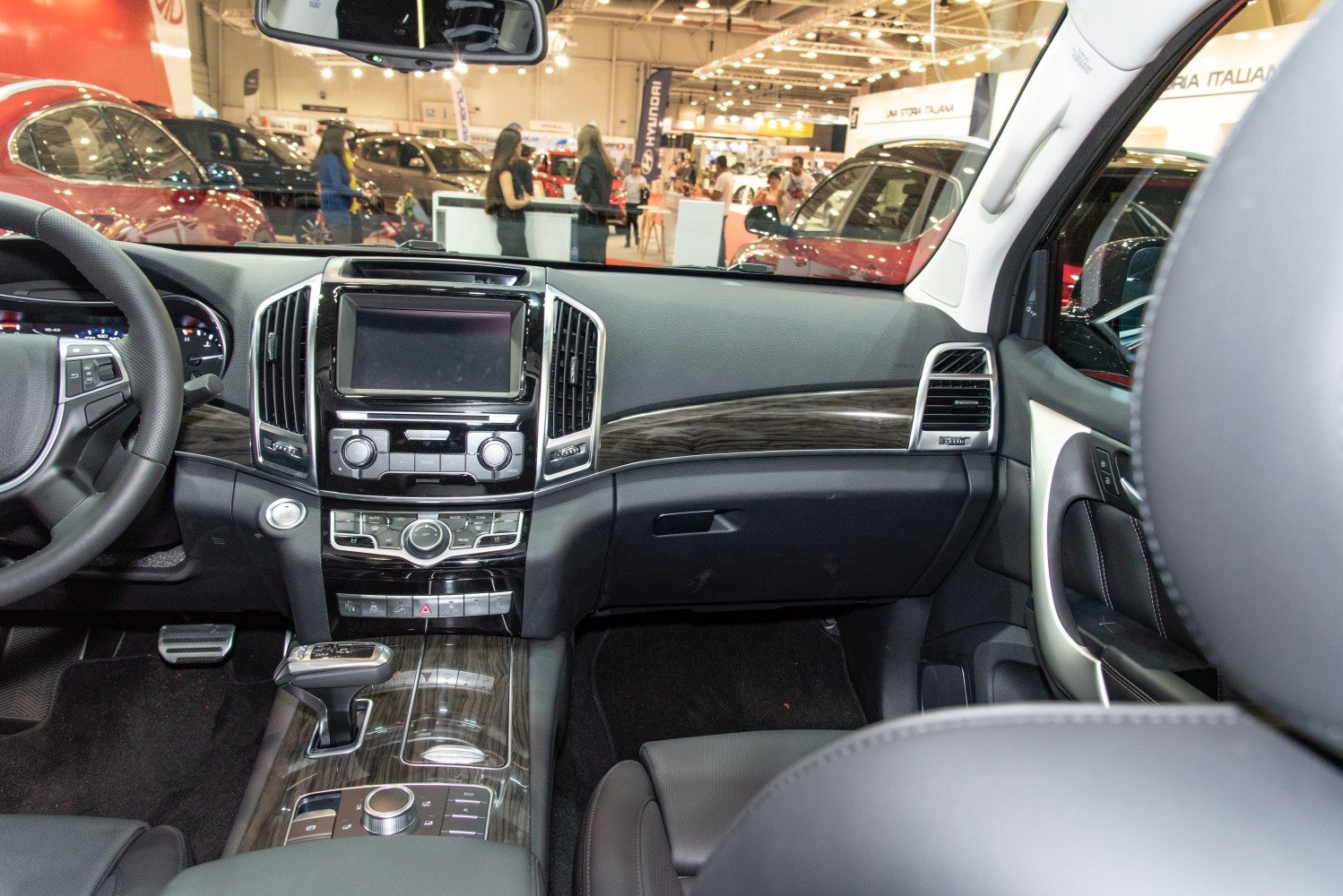 SUV interior dashboard with wood trim and touchscreen display