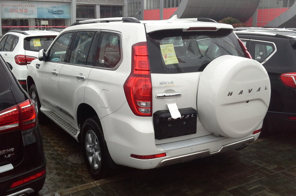 Rear SUV showing mounted spare tire holder and vertical taillights