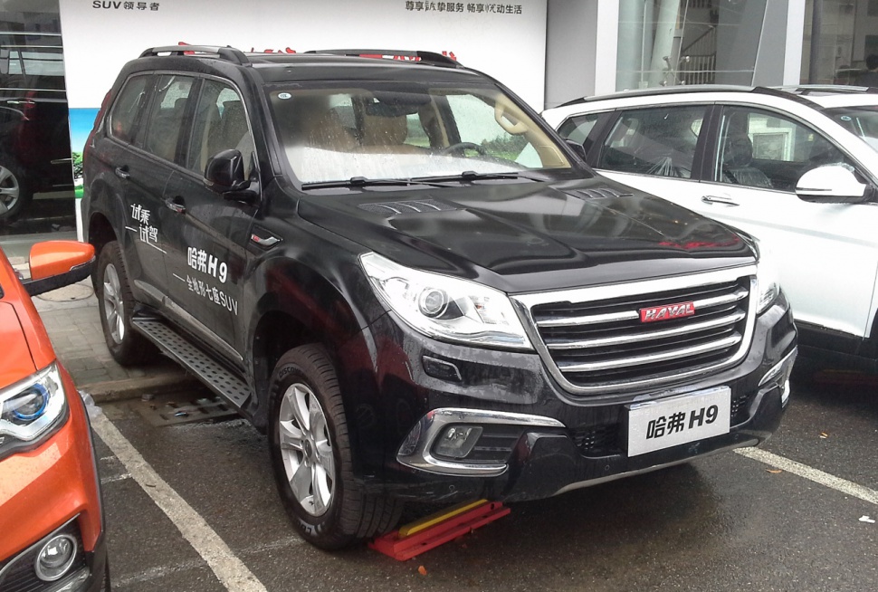 Black SUV front angled view with chrome grille and modern headlights