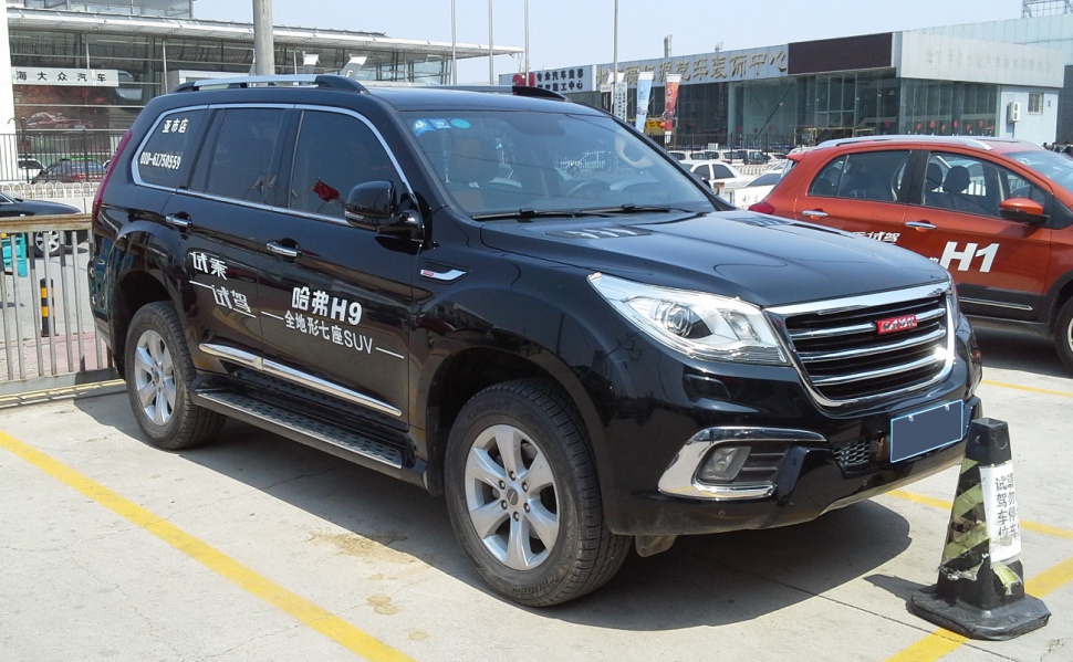 Black mid-size SUV with front grille and alloy wheels parked outdoors