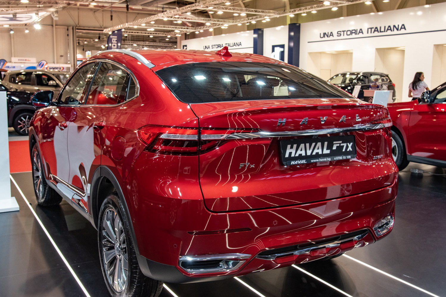 Rear view of a red SUV with LED tail lights and sloping roofline