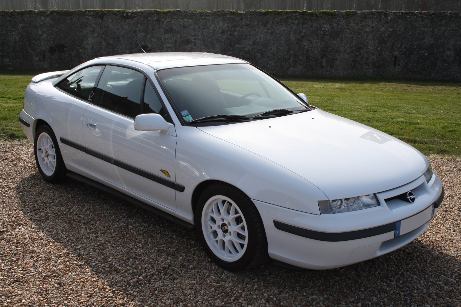 White BBS alloy wheels on a sleek aerodynamic coupe body.