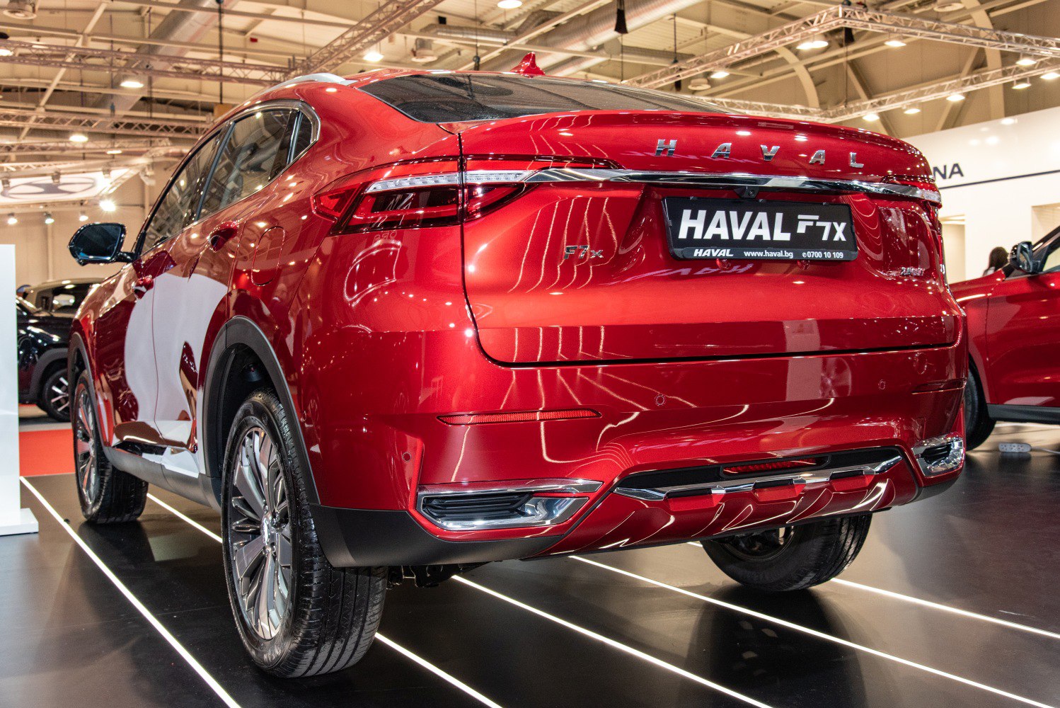 Rear view of red SUV with LED tail lights and sleek rear bumper