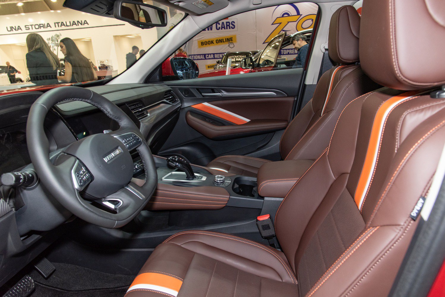 Modern leather interior with orange accent stitching and advanced dashboard.
