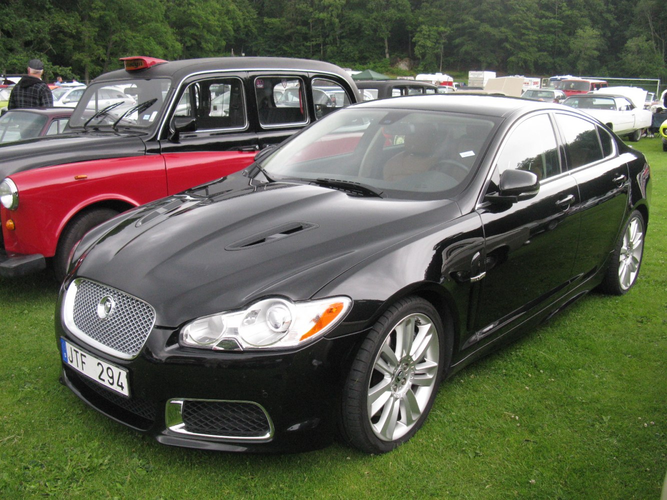 Front side view of a sleek luxury sedan with sporty alloy wheels