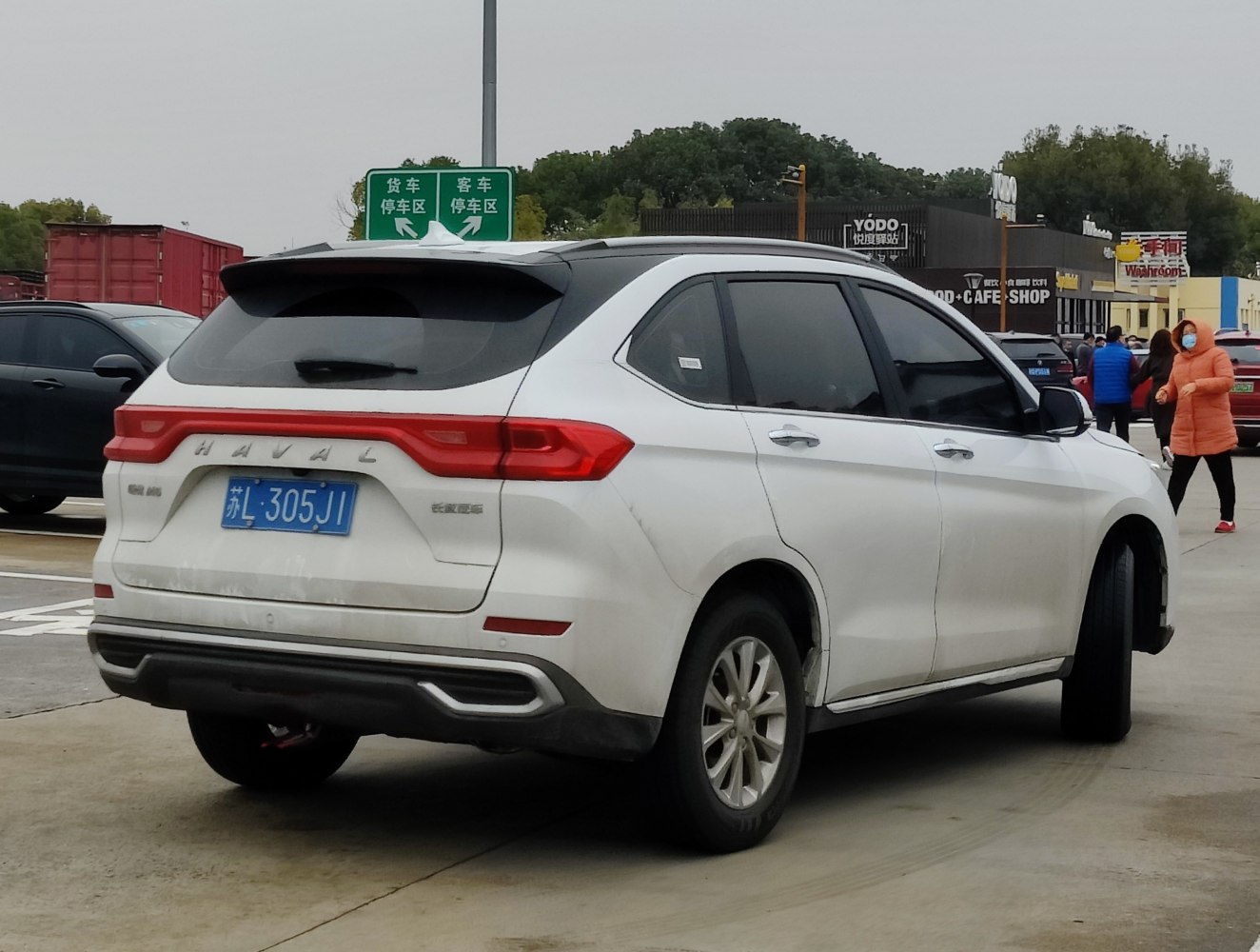 Rear view of white SUV with LED tail lights and sporty rear design