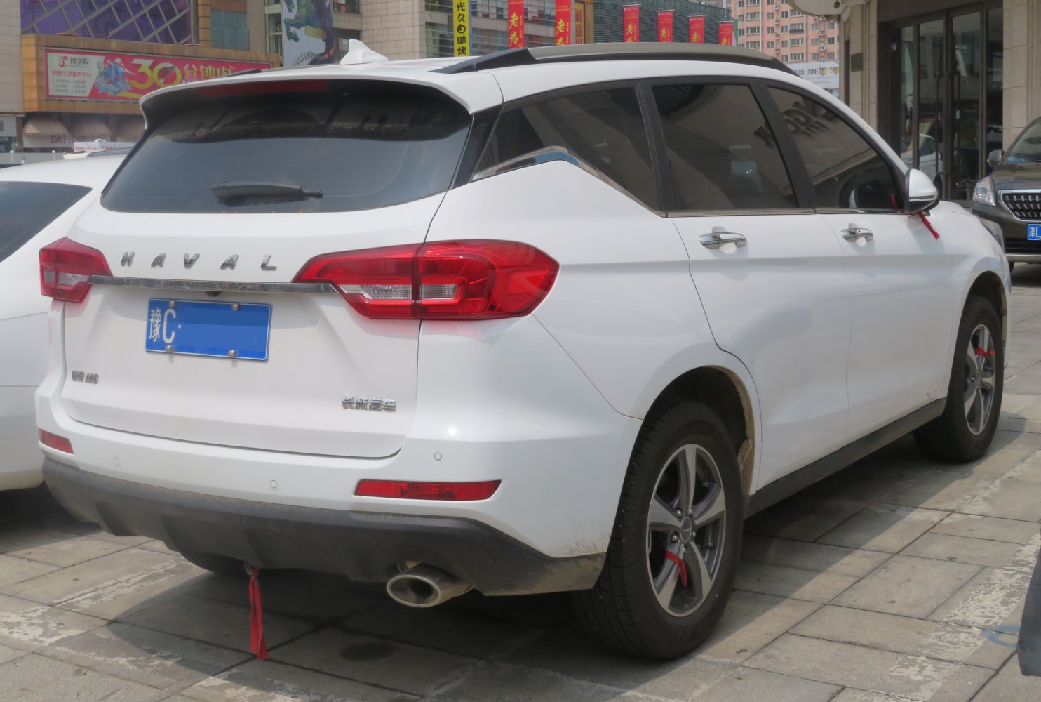 Rear view and side profile with taillights and rear spoiler.