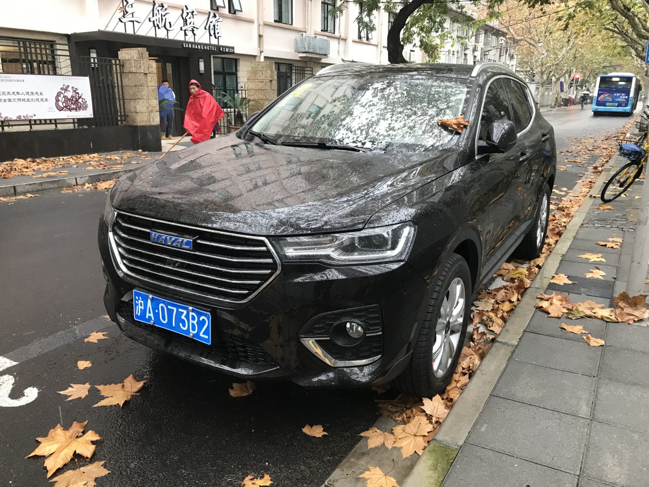 Front and side view of a black SUV with LED headlights and chrome grille.