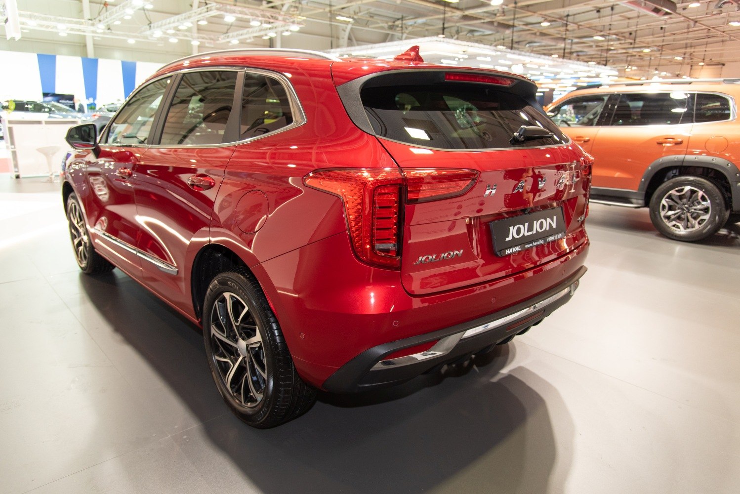 Rear and side view of a red SUV with LED taillights and alloy wheels
